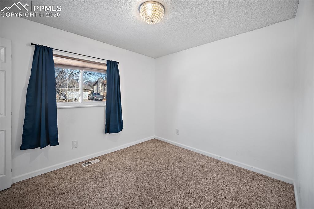 Image 24 of 37: Main level bedroom. 
 