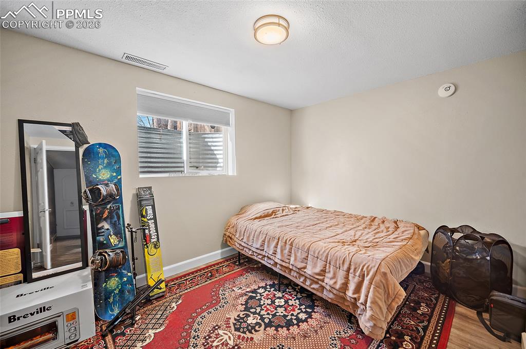 Image 26 of 37: Lower-level bedroom. 