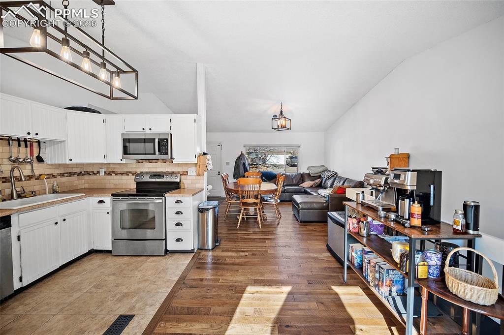 Image 6 of 37: Heart of the home connects to the living and dining area. 