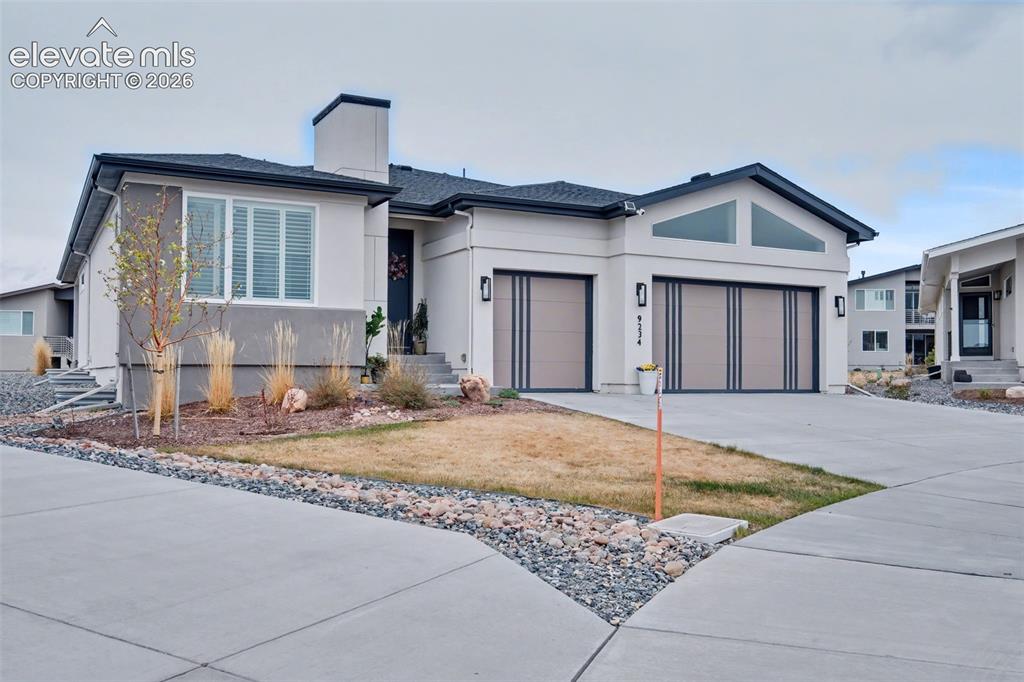 Image 2 of 41: View of front of home featuring driveway, stucco siding, a garage, and a ch
