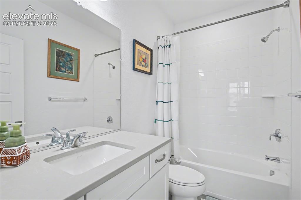 Image 23 of 41: Laundry room with a textured wall, washer and dryer, and cabinet space