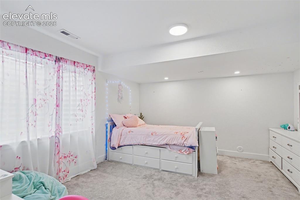 Image 25 of 41: Bedroom featuring light colored carpet, a closet, and a ceiling fan