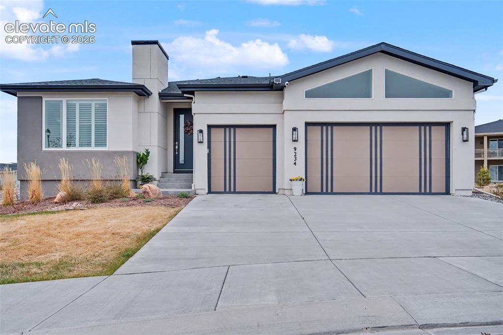 Image 3 of 41: View of front of property featuring a garage, concrete driveway, stucco sid