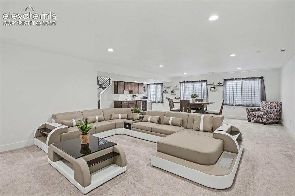 Image 31 of 41: Bathroom with double vanity, connected bathroom, and light colored carpet