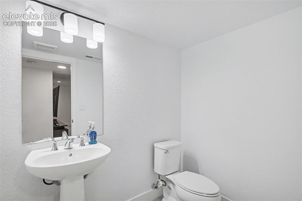 Image 34 of 41: Bedroom featuring an office area, light colored carpet, and recessed lighti