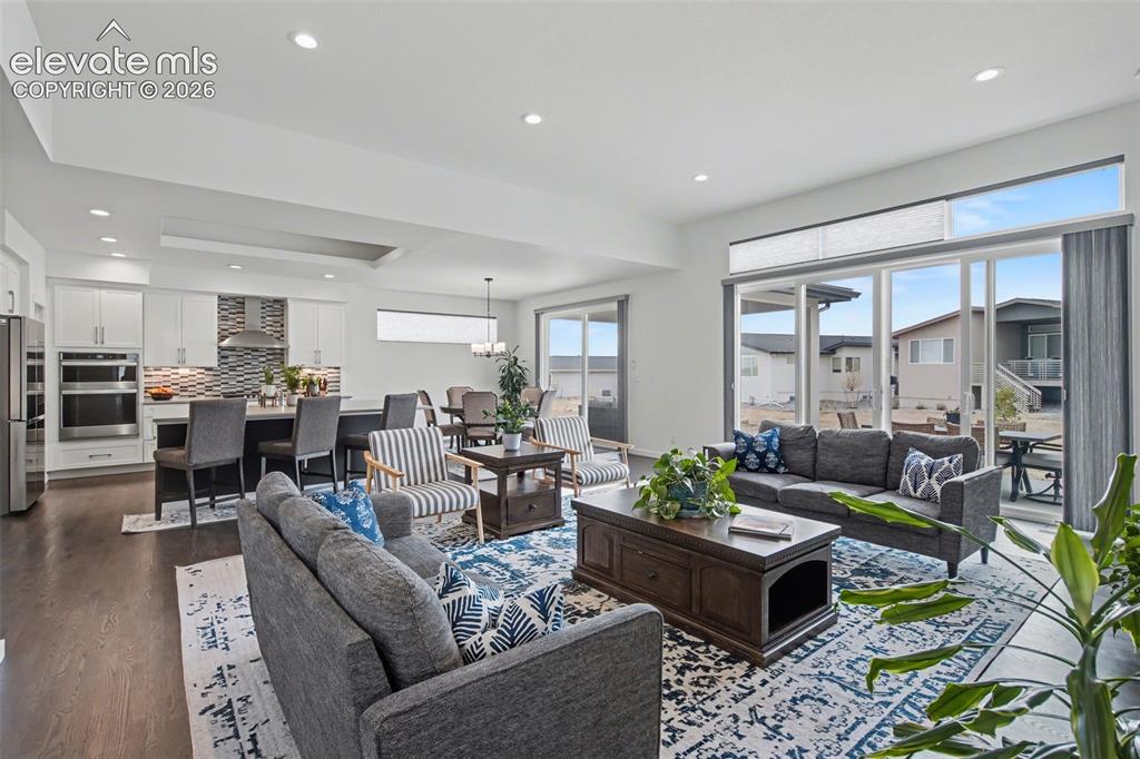 Image 5 of 41: Living room featuring recessed lighting and dark wood finished floors