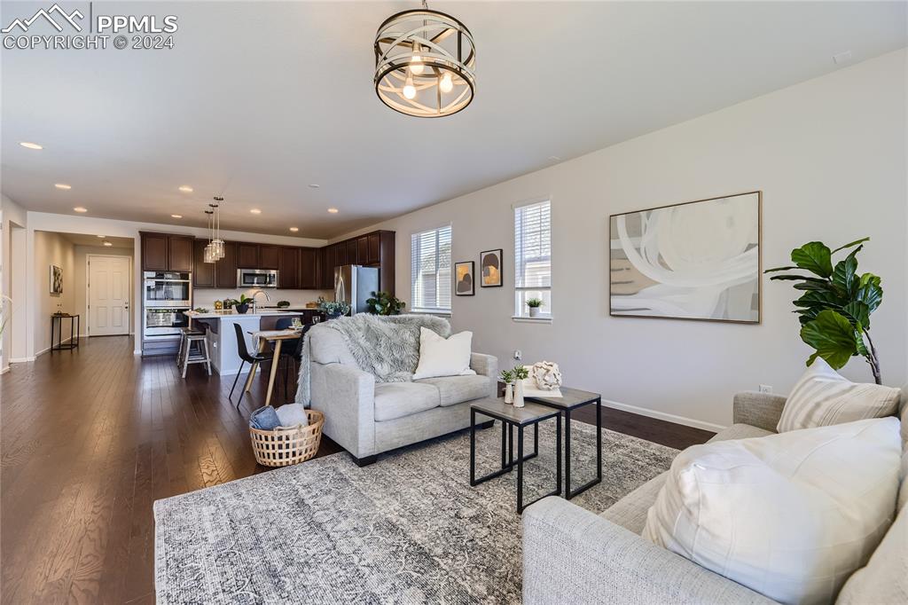 Image 10 of 50: Living room featuring dark hardwood / wood-style floors
