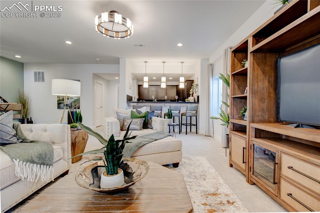 Image 22 of 26: Living area featuring recessed lighting and light colored carpet