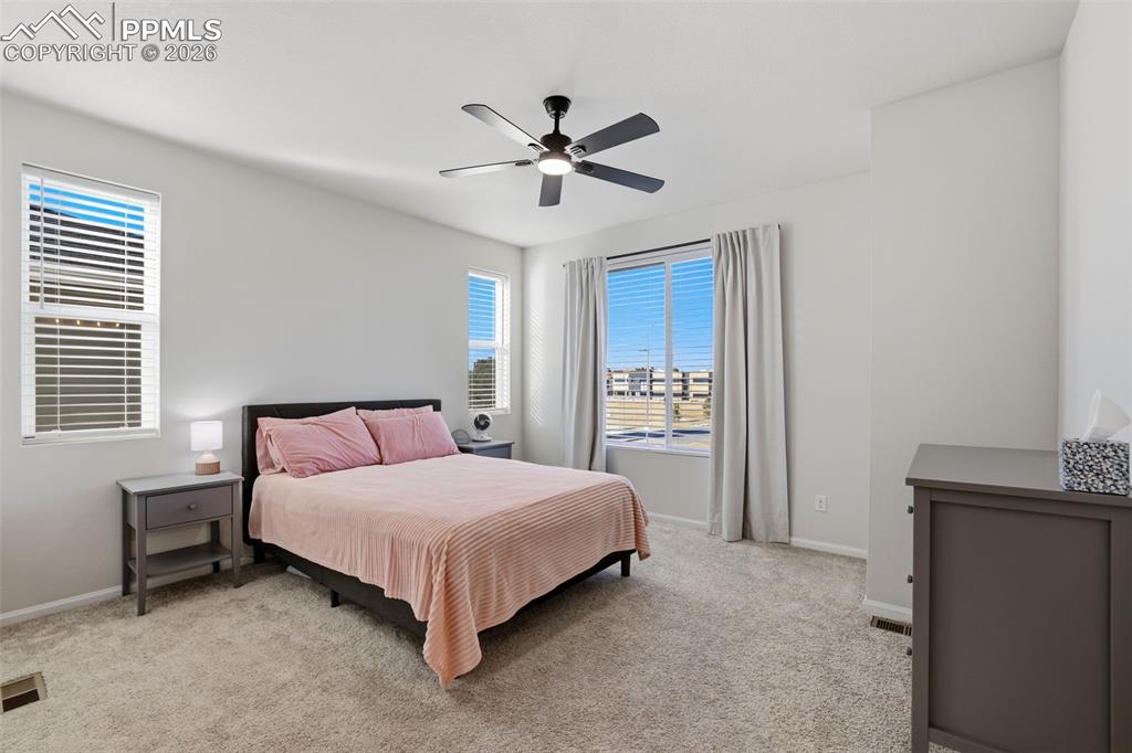 Image 17 of 28: Bedroom featuring light carpet and ceiling fan
