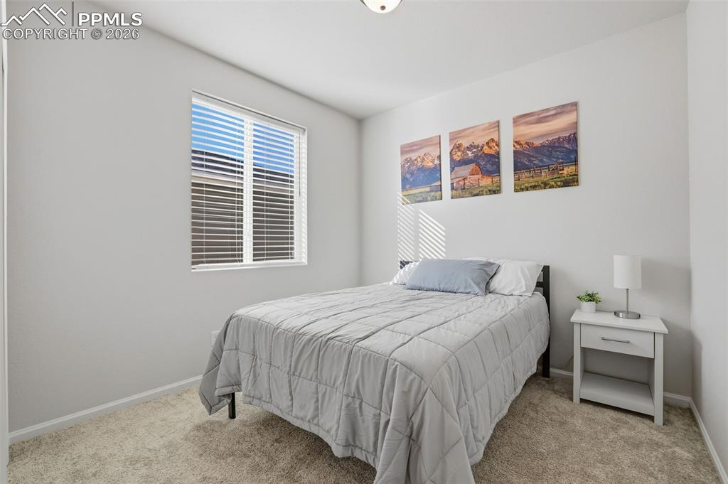 Image 22 of 28: Bedroom featuring light colored carpet