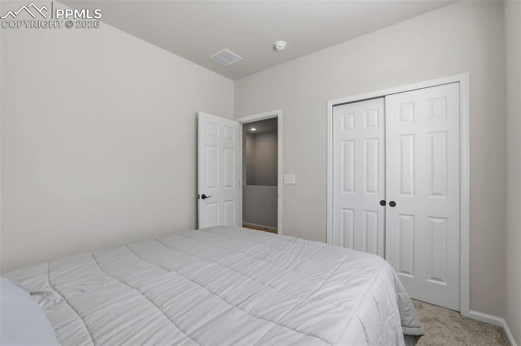 Image 23 of 28: Carpeted bedroom featuring a closet and baseboards