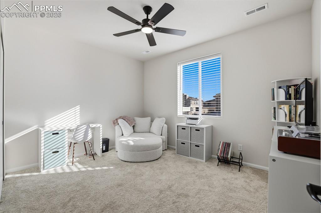 Image 24 of 28: Sitting room with carpet and ceiling fan