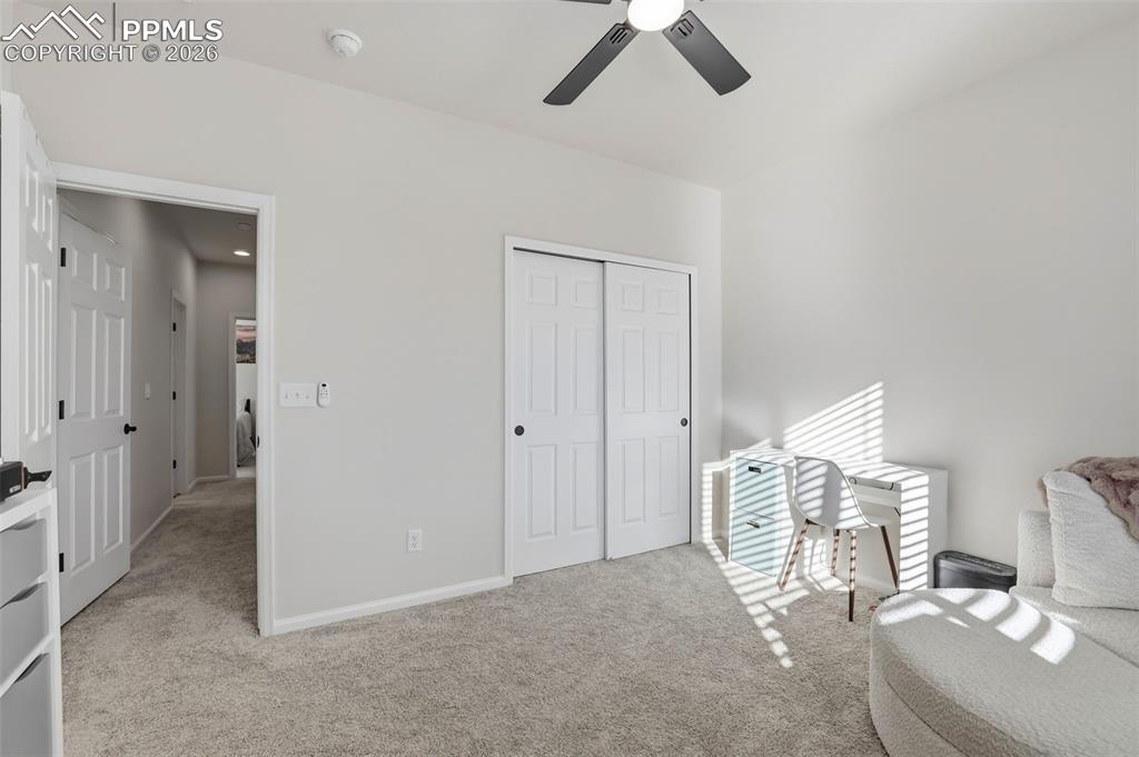 Image 25 of 28: Bedroom featuring light colored carpet, a closet, and ceiling fan