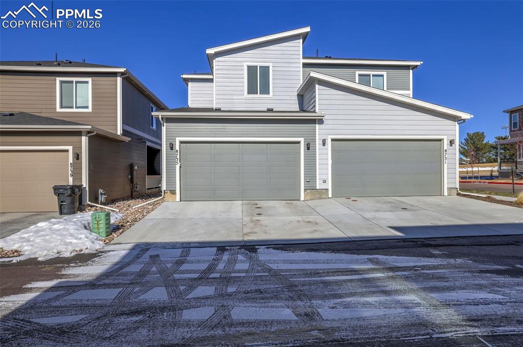 Image 27 of 28: View of front of property with an attached garage and concrete driveway