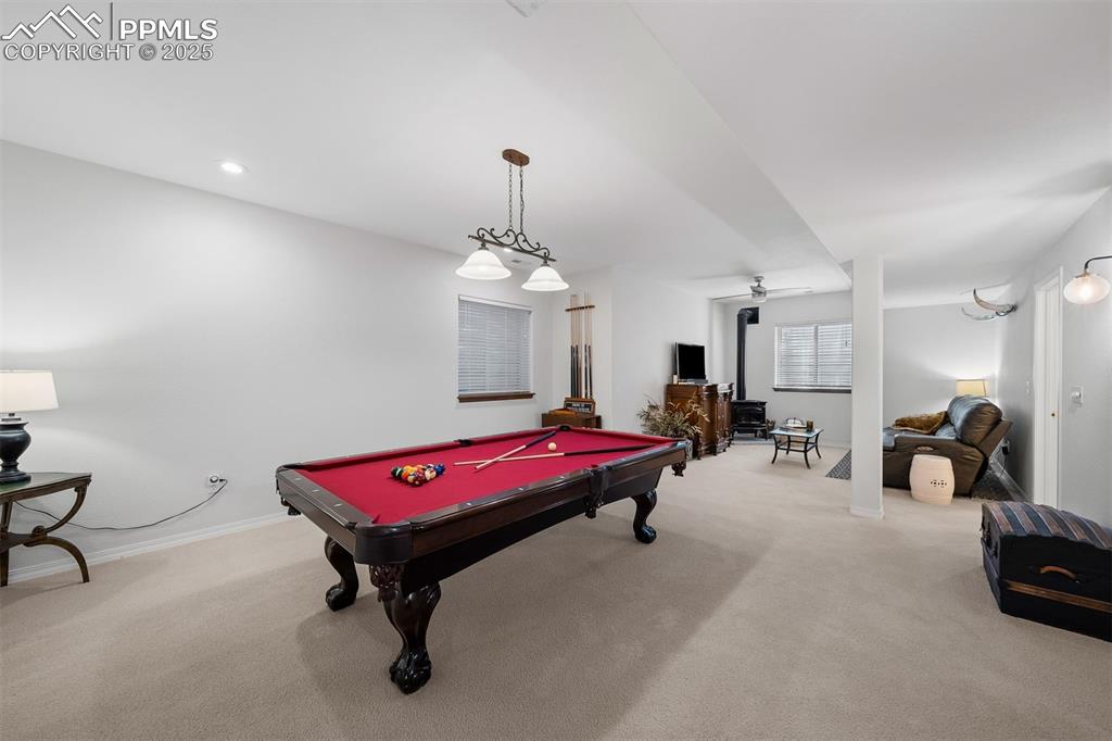 Image 21 of 30: Lower level recreation space with room for sitting areas and game table.