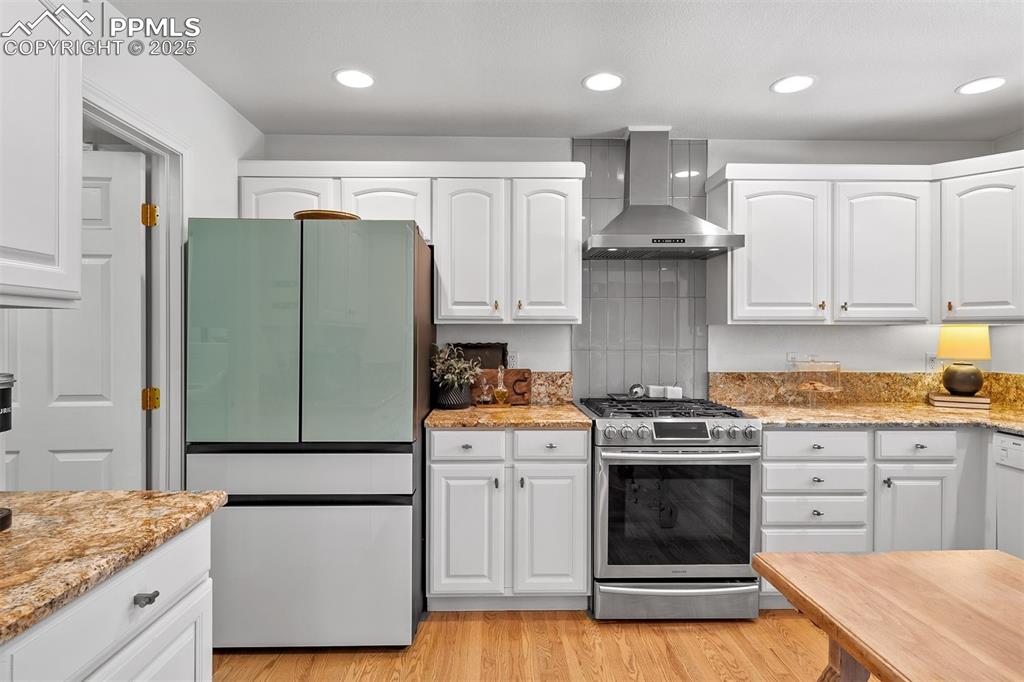 Image 7 of 30: Samsung smart refrigerator with French doors and smart gas range with gridd