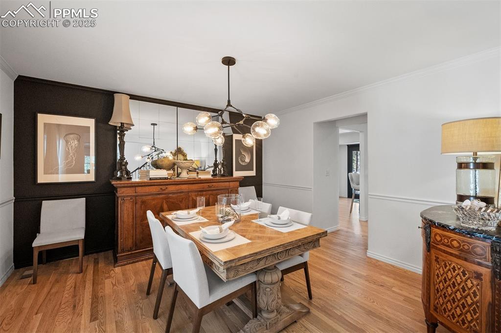 Image 9 of 30: Spacious with room for table and buffet, featuring a dark accent wall.