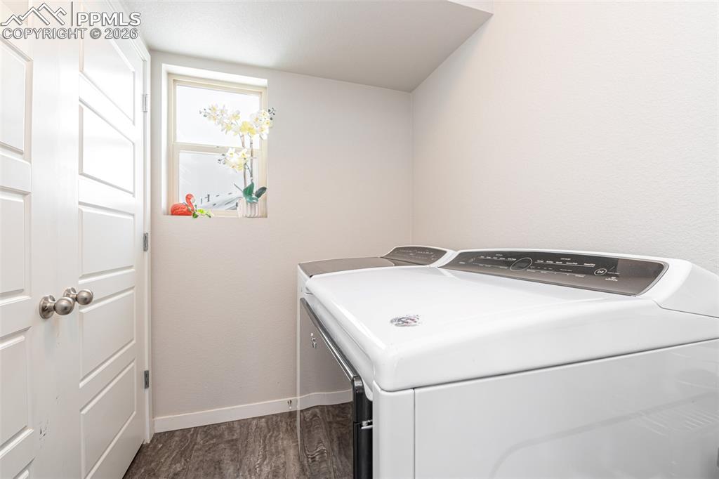 Image 20 of 29: Upstairs laundry room with window and access to the water heater and HVAC s