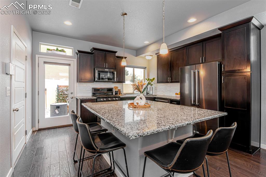 Image 8 of 29: Large granite island perfect for gatherings