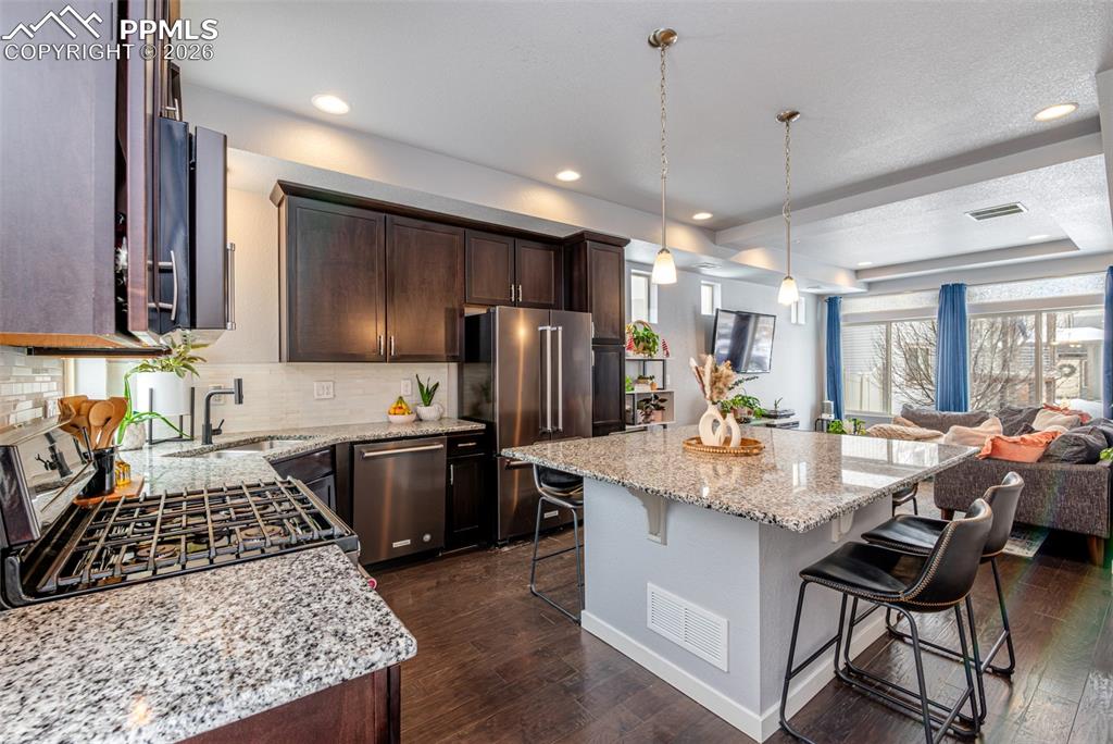 Image 9 of 29: Gas stove, built-in microwave, stainless steal dishwasher and refrigerator.