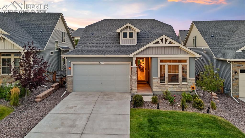 Caption: Gorgeous stucco home with stone accents and pristine landscaping!