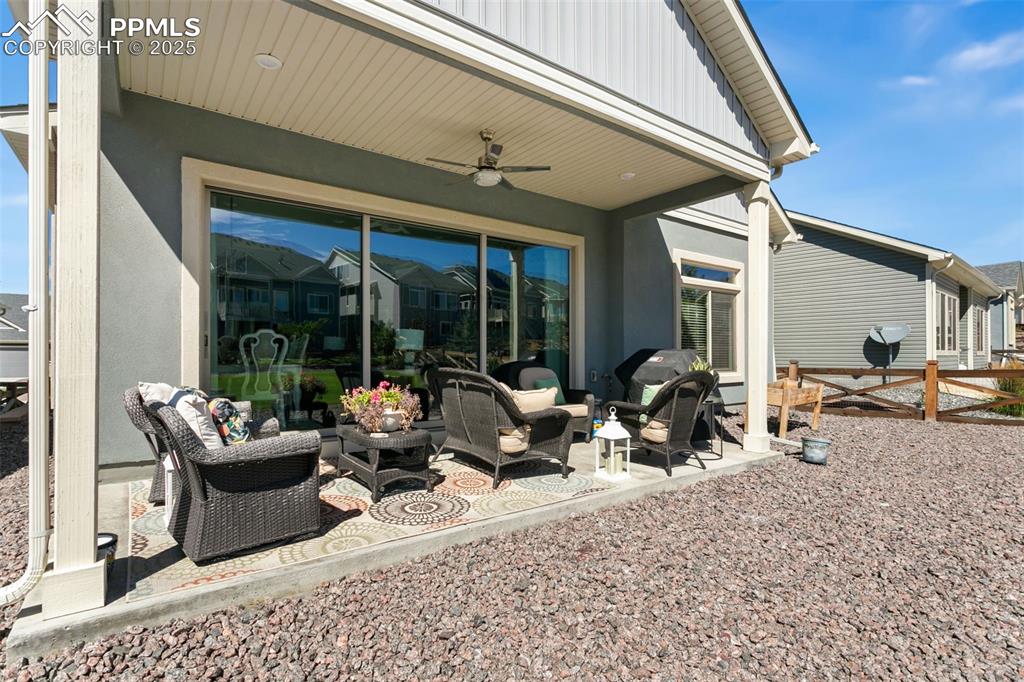 Image 27 of 35: Beautiful covered back patio offers room for an outdoor living area, al fre