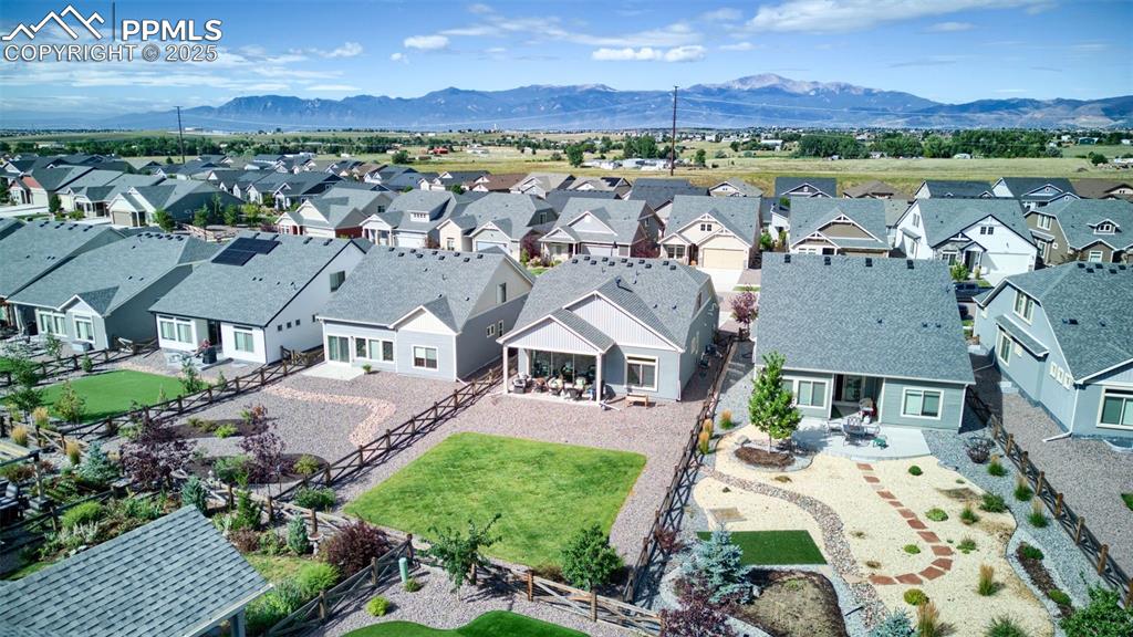 Image 4 of 35: Stunning backyard with covered patio provides space to grill, garden, or re