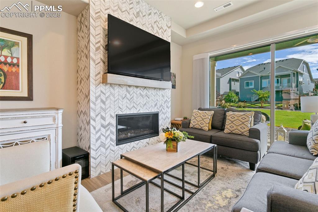 Image 6 of 35: Beautiful, upgraded fireplace anchors the living, dining, and kitchen!