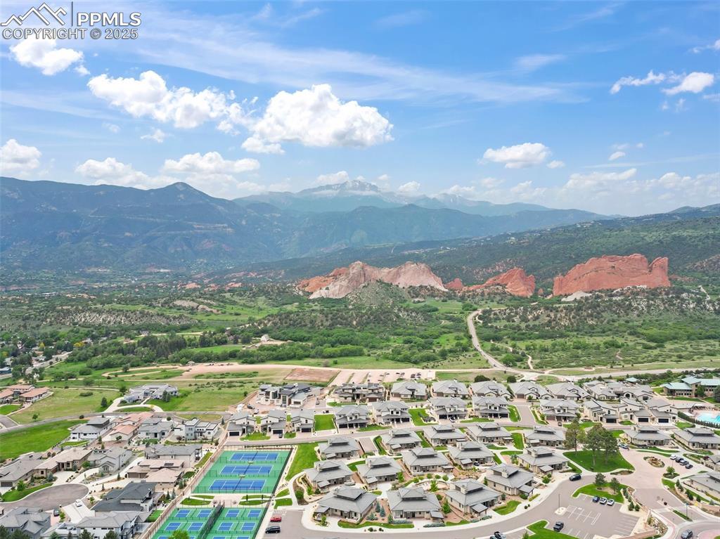 Image 12 of 24: Aerial perspective of suburban area featuring a mountainous background