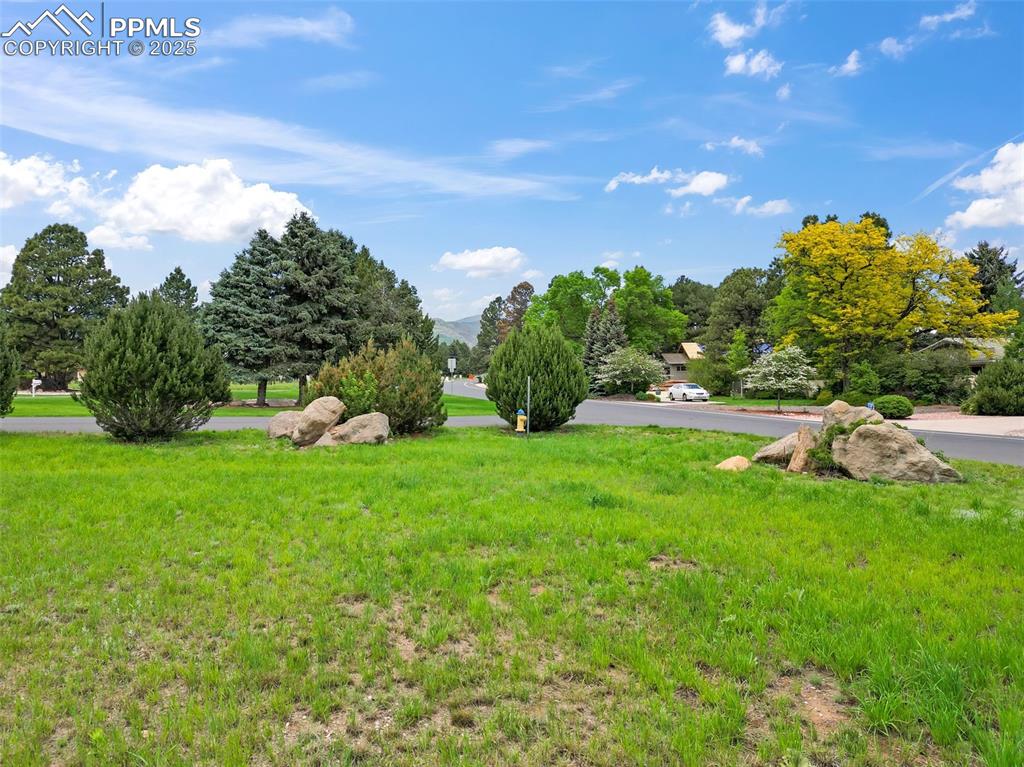 Image 14 of 24: View of green lawn with a mountain view