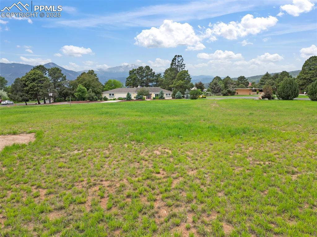 Image 15 of 24: View of green lawn with a mountain view and a view of countryside