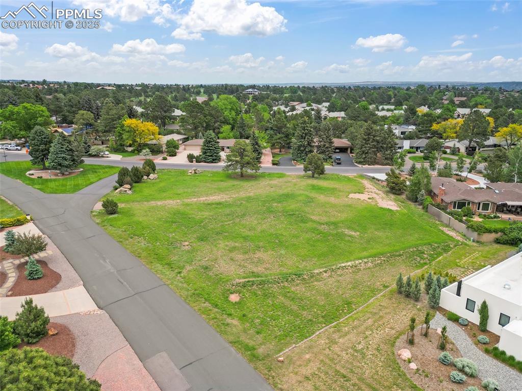 Image 3 of 24: Aerial view of residential area with a tree filled landscape