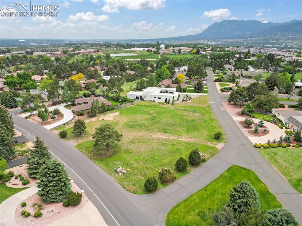 Image 7 of 24: Aerial perspective of suburban area with a mountainous background