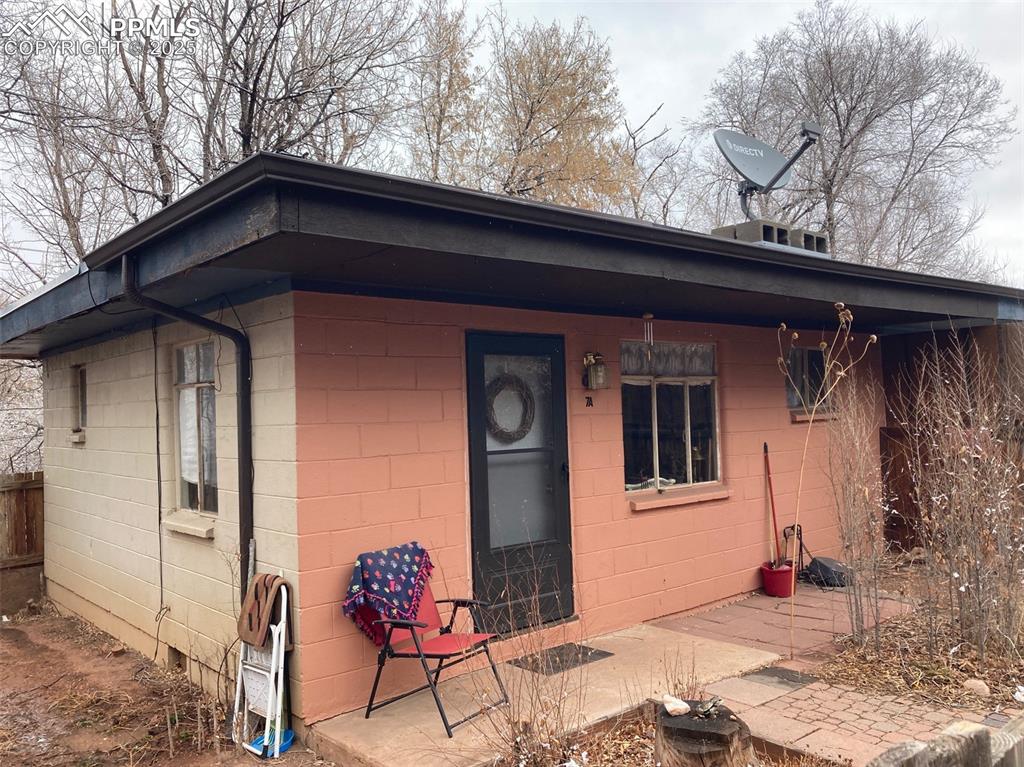 Image 1 of 11: Back of house with concrete block siding