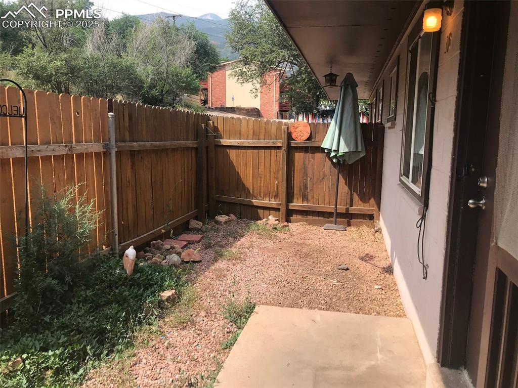 Image 11 of 11: Fenced backyard featuring a patio