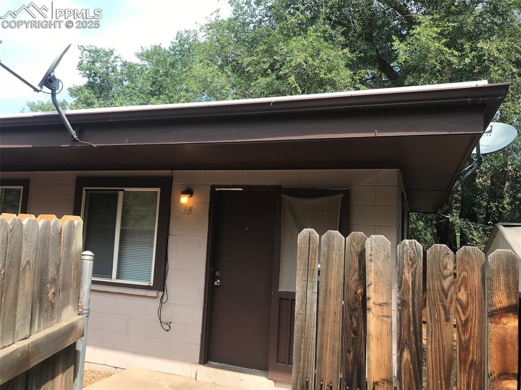 Image 3 of 11: Doorway to property featuring concrete block siding