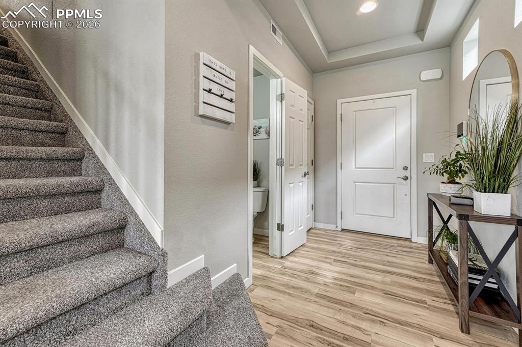 Image 10 of 50: Front Entry with LVP flooring and stairs to the upper level.