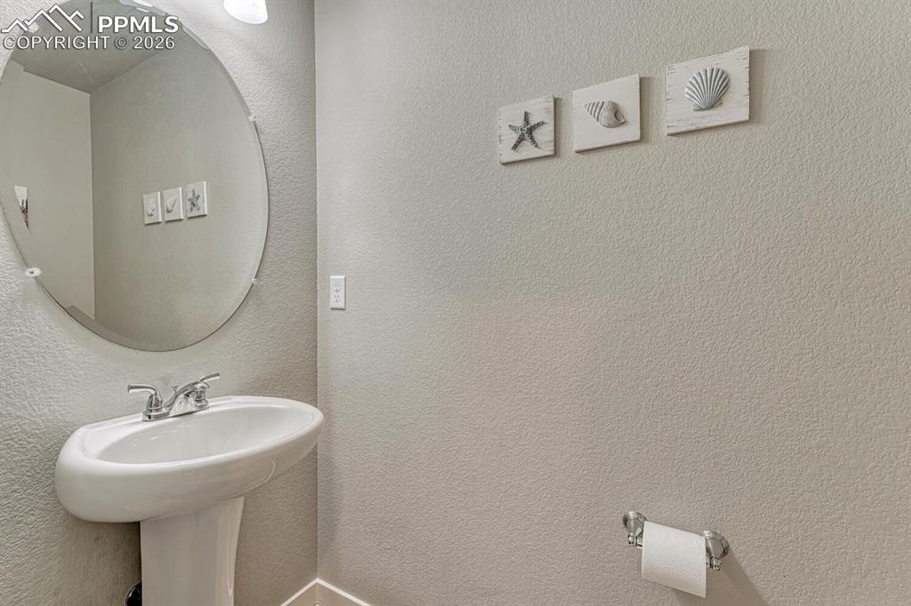 Image 11 of 50: Convenient Powder Bathroom located off the Entry.