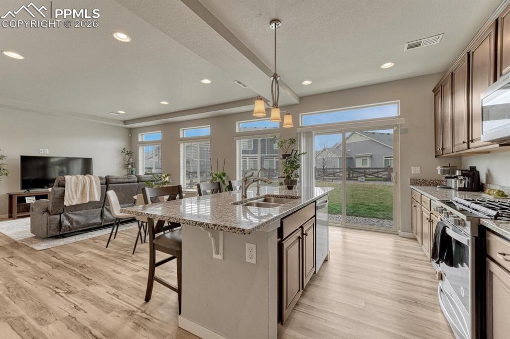 Image 16 of 50: The Kitchen has a slider door out to the backyard.