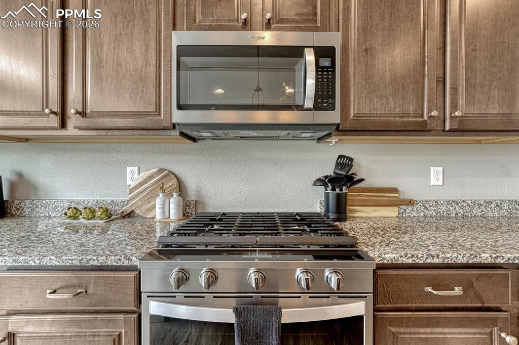 Image 19 of 50: Gas range oven and built-in microwave oven.