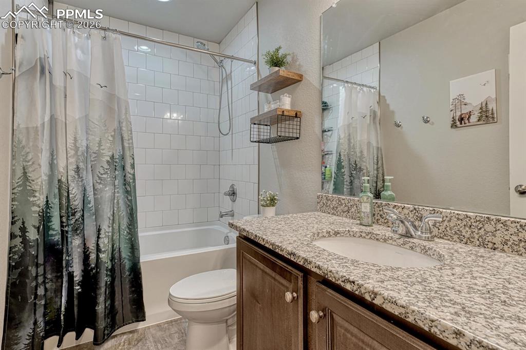 Image 25 of 50: Upper Level Hall Bathroom with vanity, mirror, and tiled tub/shower.