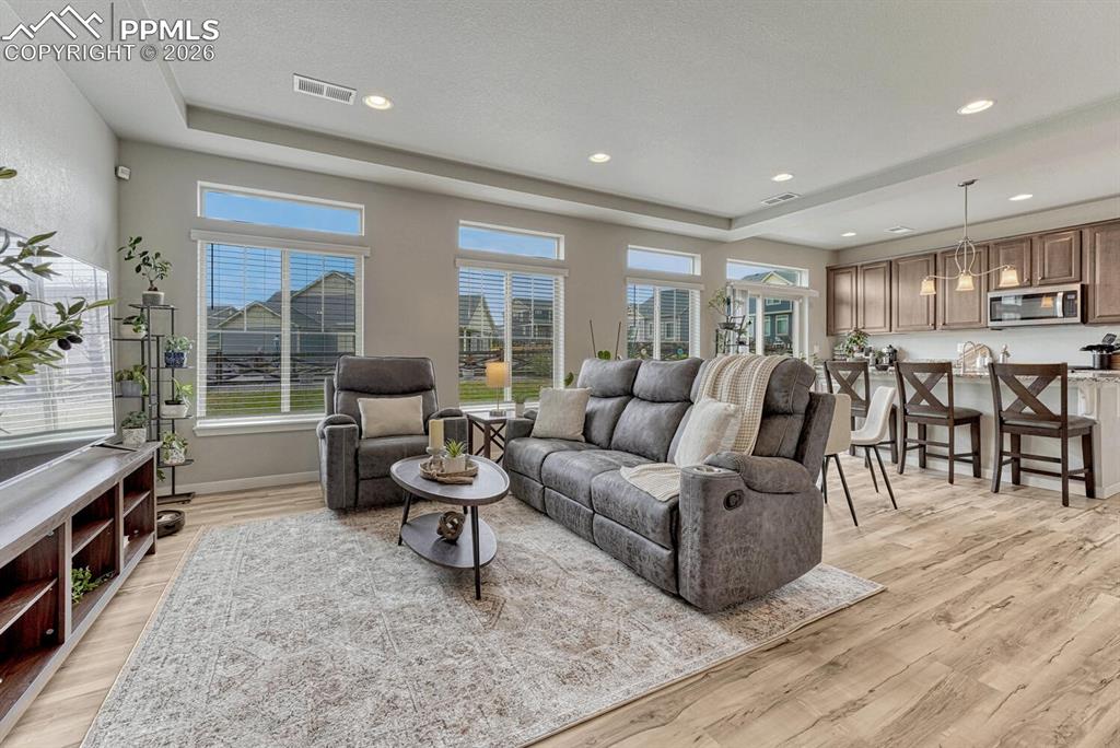 Image 3 of 50: The spacious Great Room has a wall of windows (clerestory windows - builder