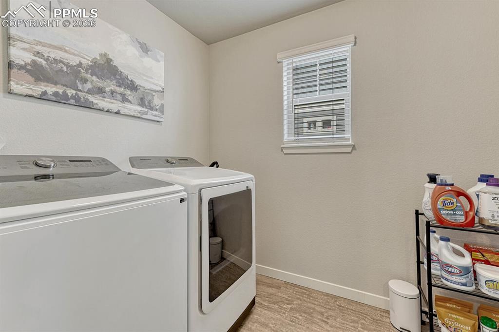 Image 33 of 50: Upper Level Laundry Room with window. 