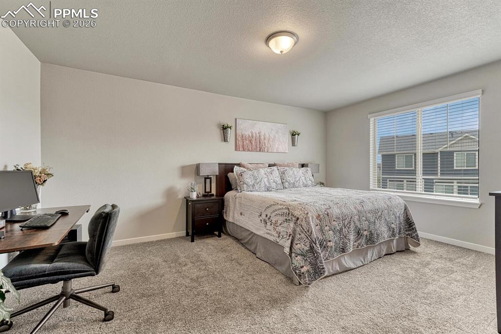 Image 5 of 50: The expansive Primary Suite serves as a private retreat with space for a si