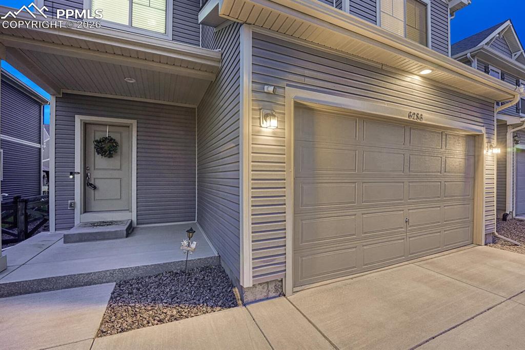Image 9 of 50: Sunset view of covered front porch.