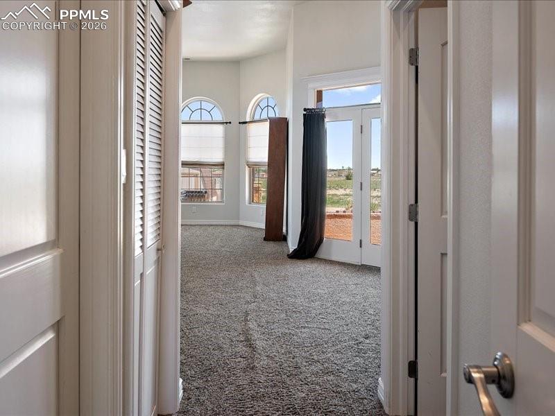 Image 16 of 48: Hallway into primary bedroom.