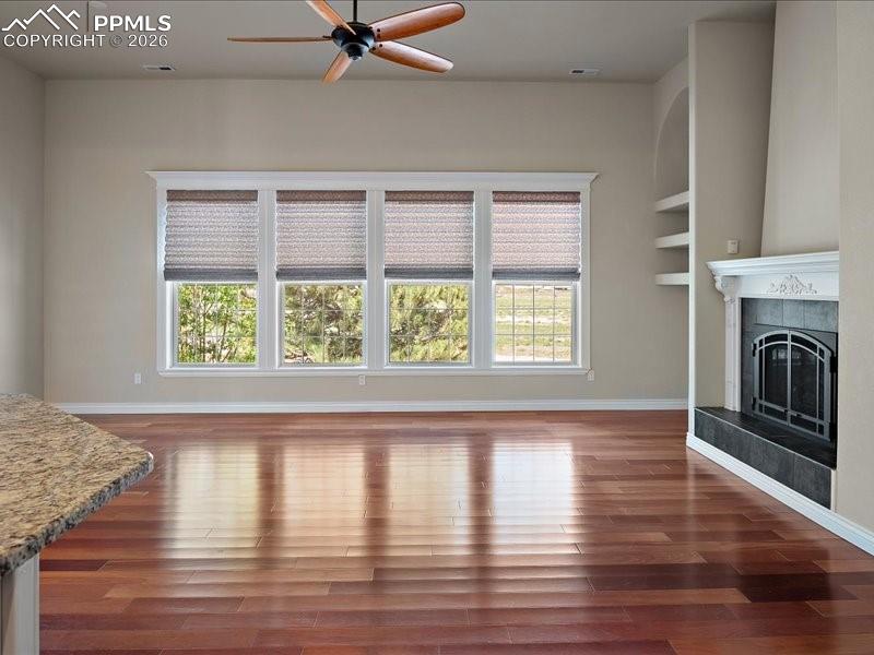 Image 30 of 48: Unfurnished living room featuring ceiling fan, healthy amount of natural li
