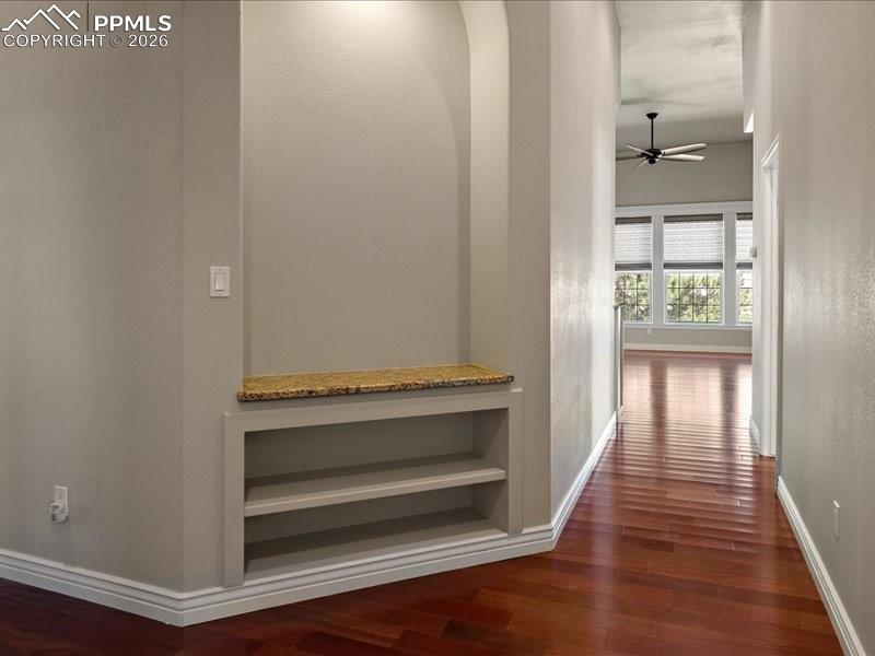 Image 36 of 48: Hallway featuring dark wood-style floors and a textured wall
