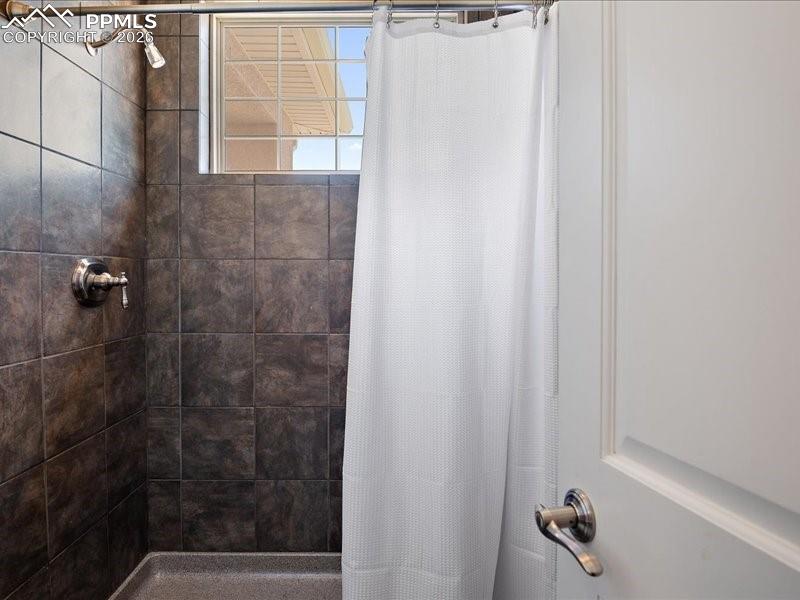 Image 39 of 48: Bathroom with tiled shower