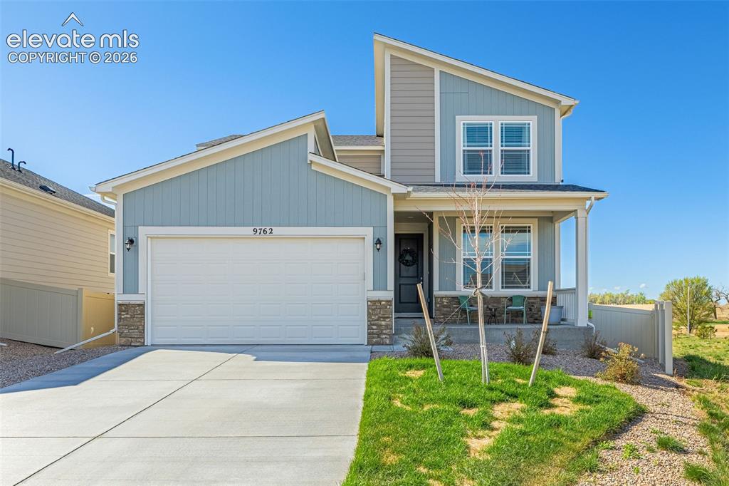 Image 1 of 50: Two-story residence featuring a covered front porch, attached garage with c
